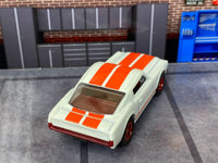 Pearl-white 1965 Mustang GT custom Matchbox, rear view with orange-red stripes