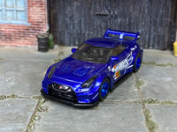 Nissan 35GT-RR custom with blue mag wheels, side view