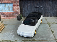 Pearl-white Subaru SVX custom Matchbox, front view with smoke-tinted glazing