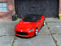 Red custom 2023 Nissan Z showing headlights and Nissan badge, front three-quarter view