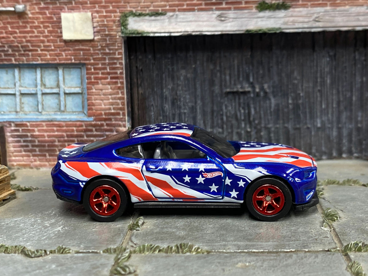 Blue custom 2018 Ford Mustang GT with Stars and Stripes graphics, right-side view