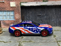 Blue custom 2018 Ford Mustang GT with Stars and Stripes graphics, right-side view