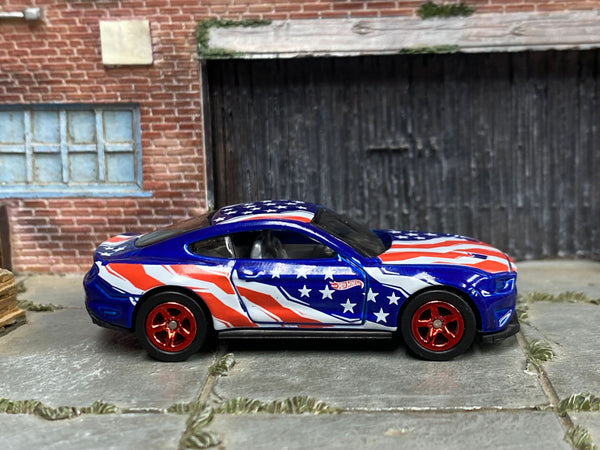 Blue custom 2018 Ford Mustang GT with Stars and Stripes graphics, right-side view