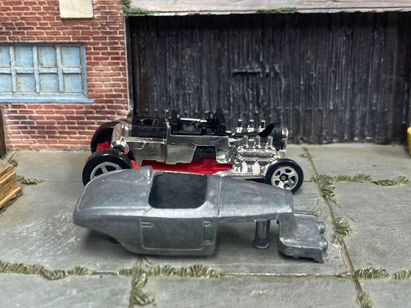 Stripped Max Steel Hot Rod body beside its matching donor chassis and engine assembly