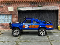 Blue K&N 1973 Jeep J10 custom with Goodyear tires, left-side view