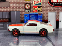 Pearl-white 1965 Mustang GT custom Matchbox, right side with raised-letter tires