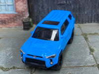 Blue 2018 Toyota 4Runner custom Matchbox, front view with detailed headlamps