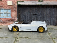 Pearl-white and gold Pagani Huayra Roadster, opposite side view