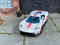 Custom 2017 Ford GT showing blue glazing and red-and-blue stripes, front three-quarter view