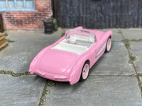Pink-and-white custom 1956 Chevrolet Corvette convertible, rear three-quarter view