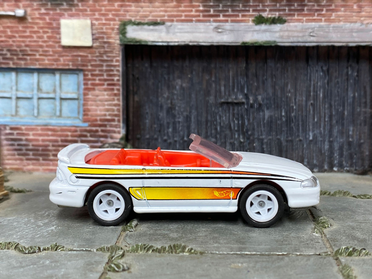 White, orange and yellow 1996 Mustang GT Convertible, front three-quarter view