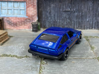 Custom Alfa Romeo GTV6 3.0 with black and chrome mag wheels, side view