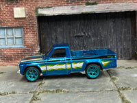 Metallic-blue custom Mazda REPU with white-and-lime graphics, left-side view