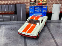 Pearl-white 1965 Mustang GT custom Matchbox, front view with twin orange-red stripes