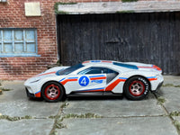 White custom 2017 Ford GT with Hot Wheels graphics and number 4, left-side view