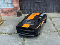 Custom 2013 COPO Camaro showing orange roof stripe and disc wheels, rear three-quarter view