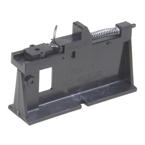 Kadee 701 coupler assembly fixture shown holding a coupler during assembly