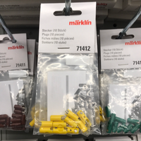 Märklin 71412 yellow ten-plug package at the center of a retail display; surrounding products are not included.