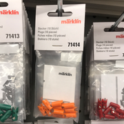 Märklin 71414 orange ten-plug package at the center of a retail display; surrounding products are not included.