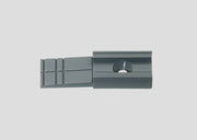One gray Märklin 74110 catenary mast base with its mounting hole and trimmable end.