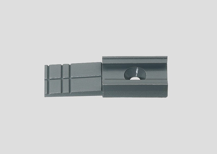 One gray Märklin 74110 catenary mast base with its mounting hole and trimmable end.