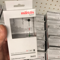 Exact Märklin 76472 signal in its labeled retail package; background packages are not included.