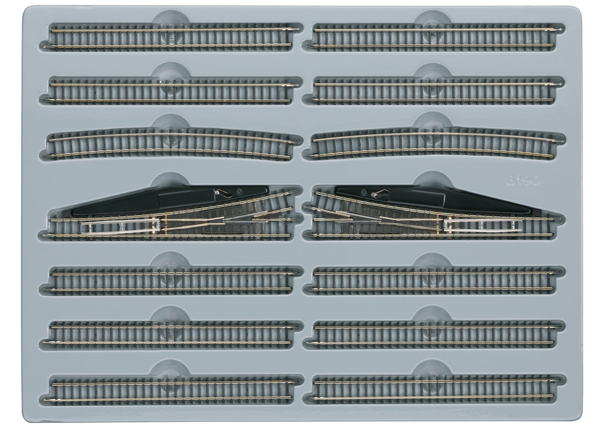 Märklin 8190 E extension set arranged in its tray with straight tracks, curves and two manual turnouts.