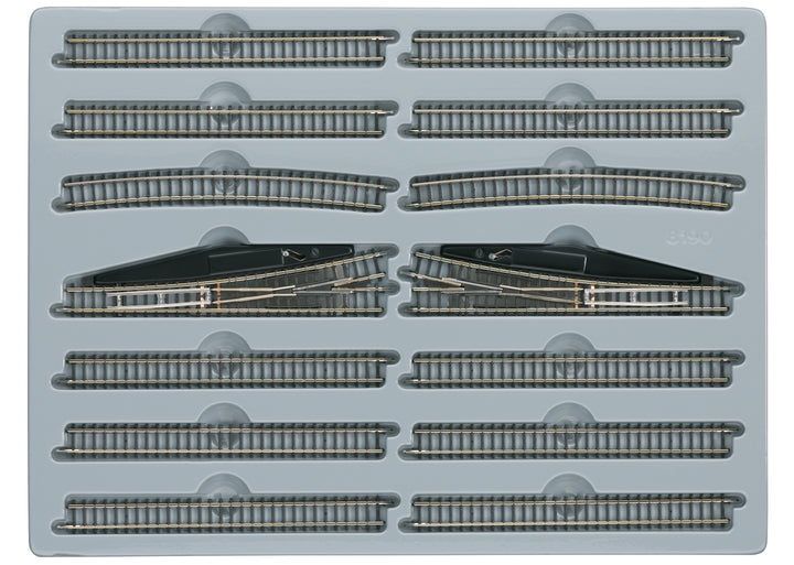 Märklin 8190 E extension set arranged in its tray with straight tracks, curves and two manual turnouts.