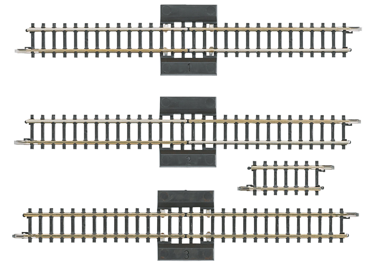 Four Märklin 8993 Z scale reversing-loop sections: three long separation tracks and one short straight.