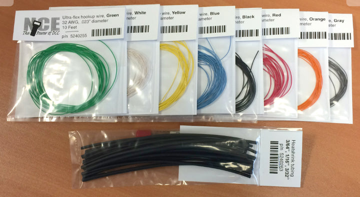 NCE 524-242 kit showing eight labeled wire-color packets and an assortment of heat-shrink tubing