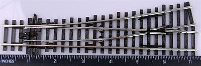 Physical PECO SL-92 left-hand small-radius turnout photographed beside a ruler