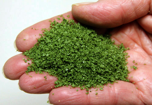 Scenic Express Medium Green SuperLeaf flakes displayed in a hand as a close-up material sample
