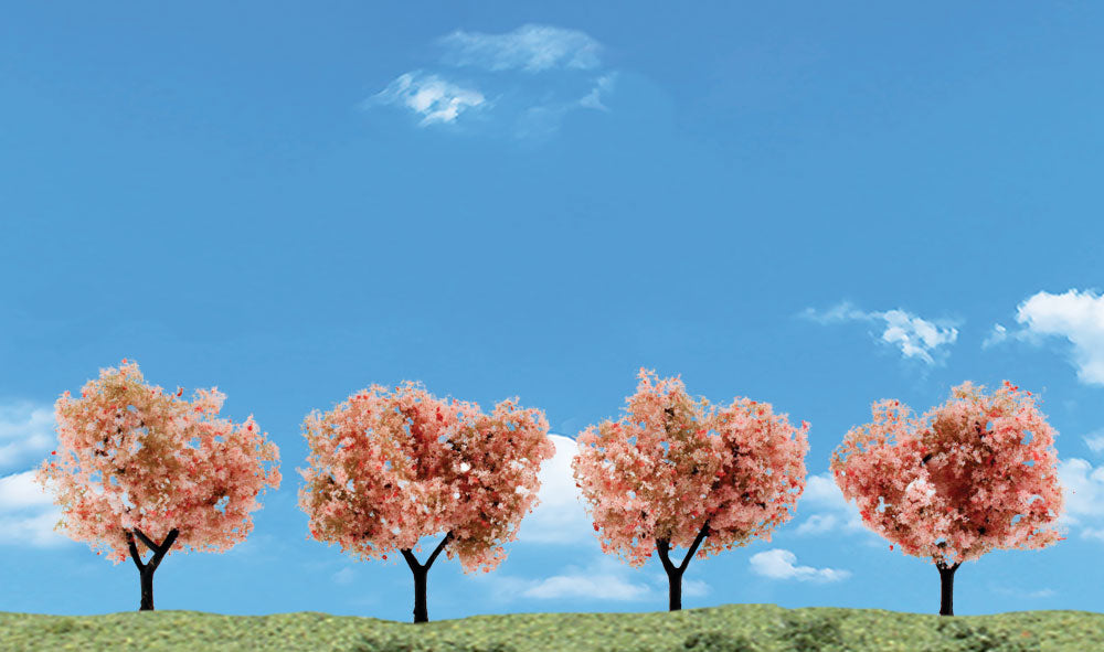Woodland Scenics TR3593 four flowering model trees with pink blossoms; display landscape is not included.