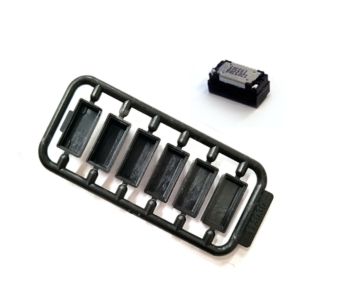 SoundTraxx 810162 Mini Cube 3 speaker beside the included baffle components