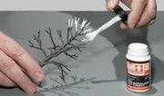 Woodland Scenics S195 Hob-e-Tac Scenic Adhesive 2 fl oz / 59.1 ml application photograph, scenery sold separately