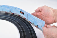 AFX Race Barrier flexible graphic barrier on curved HO slot car track