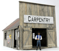 Banta Modelworks 6125 O scale Blacksmith and Carpentry Shop kit, assembled carpentry shop version; figure is separate.