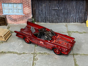 Custom Hot Wheels 1966 TV Batmobile metallic red finish with gray, red, and black Batman graphics with red wheels and rubber tires - three-quarter view