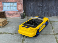 Custom Hot Wheels 1996 Mustang GT Convertible in yellow and blue Butterfinger livery with blue mag wheels and rubber tires