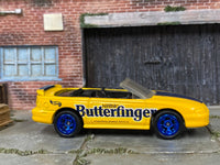 Custom Hot Wheels 1996 Mustang GT Convertible in yellow and blue Butterfinger livery with blue mag wheels and rubber tires