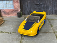 Custom Hot Wheels 1996 Mustang GT Convertible in yellow and blue Butterfinger livery with blue mag wheels and rubber tires