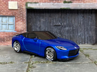 Front three-quarter view of custom Hot Wheels 2023 Nissan Z with chrome wheels and Dunlop tires