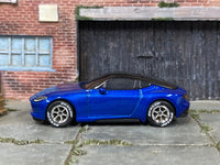Left-side view of custom Hot Wheels 2023 Nissan Z with chrome wheels and Dunlop-lettered tires