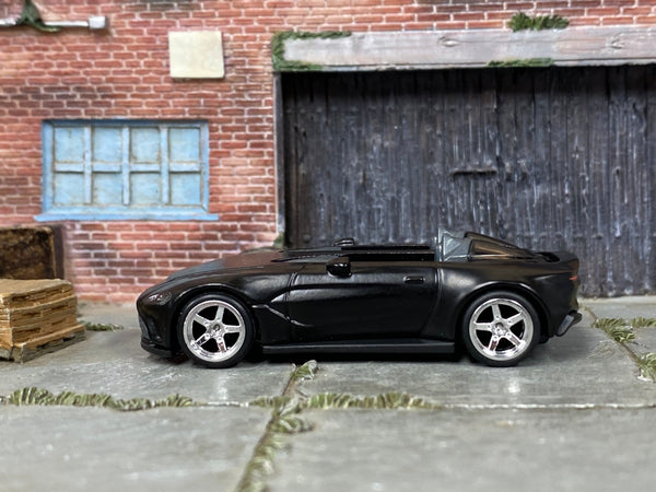 Custom Hot Wheels Aston Martin V12 Speedster in satin black with chrome race wheels and rubber tires