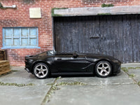 Custom Hot Wheels Aston Martin V12 Speedster in satin black with chrome race wheels and rubber tires