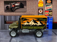 Olive-green Baja Hauler custom Hot Wheels, right side with mountain graphics and silver wheels