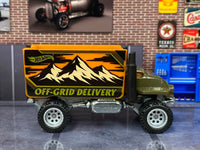 Olive-green Baja Hauler custom Hot Wheels, left side with orange Off-Grid Delivery cargo box