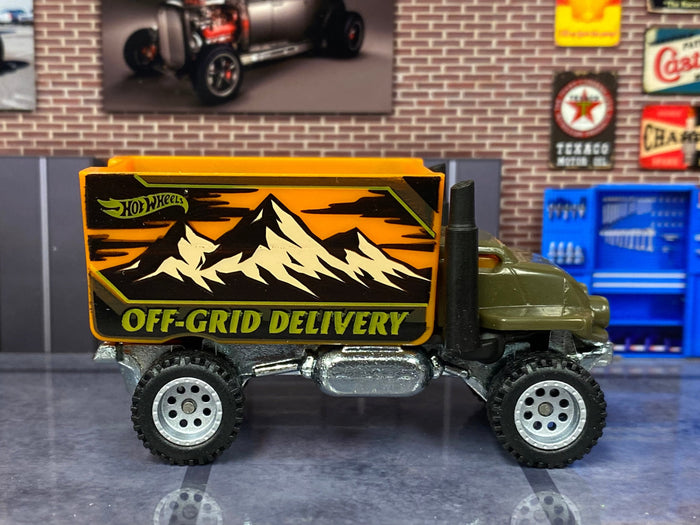 Olive-green Baja Hauler custom Hot Wheels, left side with orange Off-Grid Delivery cargo box