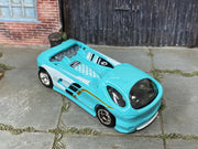 Custom Hot Wheels Deora II aqua blue with white, black, and gold graphics with chrome wheels and rubber tires - three-quarter view