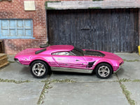 Exhausted metallic-pink custom Hot Wheels with silver graphics and chrome wheels, view 1